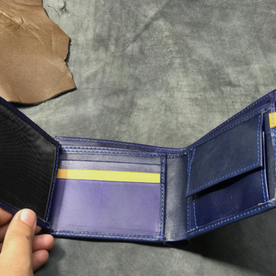blue and yellow trifold wallet with buttoned strip